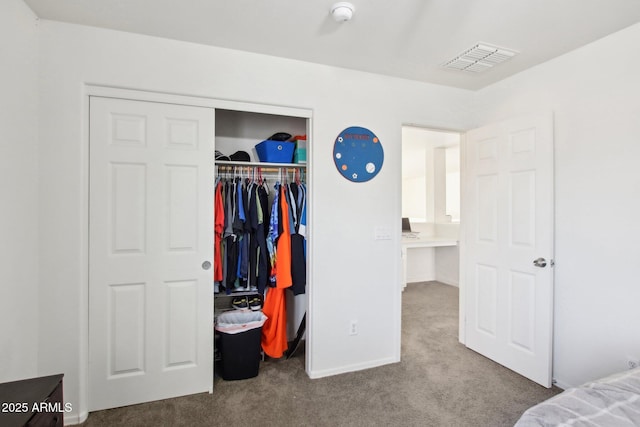 bedroom featuring light colored carpet and a closet