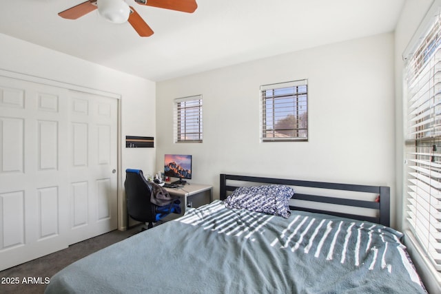 carpeted bedroom with a closet and ceiling fan