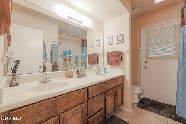 bathroom featuring tile patterned floors, vanity, and toilet