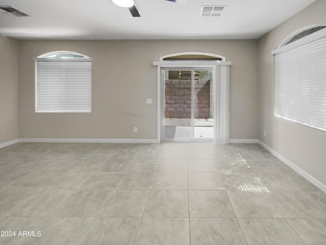 unfurnished room featuring ceiling fan and light tile patterned floors