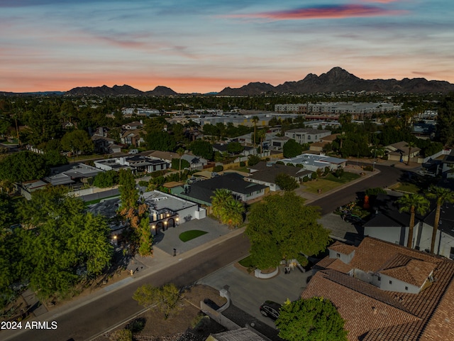 aerial view at dusk featuring a mountain view