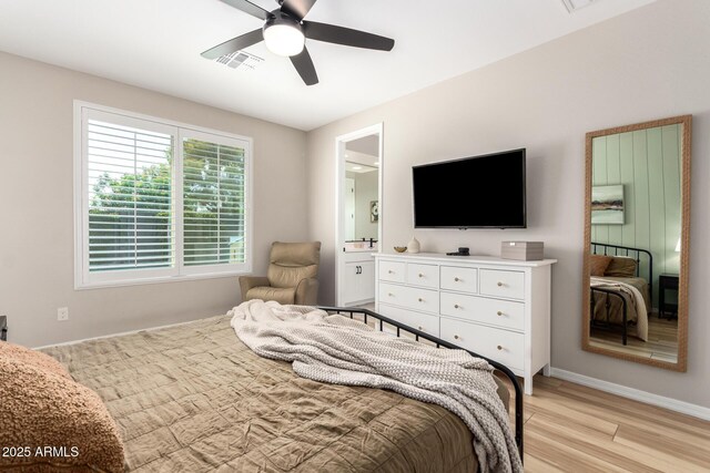 6550 S 24th Pl, Phoenix, AZ 85042 - bedroom featuring light wood-style floors, baseboards, ceiling fan, and ensuite bathroom