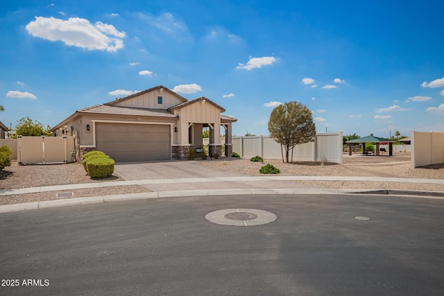 6550 S 24th Pl, Phoenix, AZ 85042 - view of front facade with a garage, driveway, stone siding, and a gate