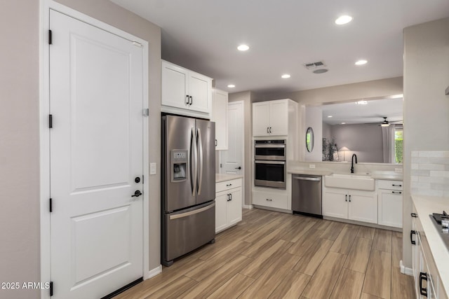 6550 S 24th Pl, Phoenix, AZ 85042 - kitchen with appliances with stainless steel finishes, a sink, light countertops, ceiling fan, and recessed lighting