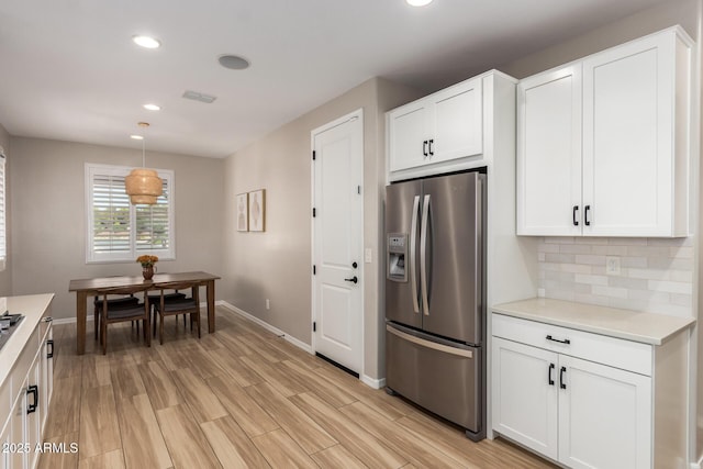6550 S 24th Pl, Phoenix, AZ 85042 - kitchen featuring stainless steel fridge with ice dispenser, baseboards, light countertops, white cabinetry, and recessed lighting