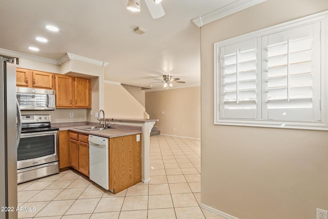 kitchen with kitchen peninsula, appliances with stainless steel finishes, light tile patterned floors, and sink