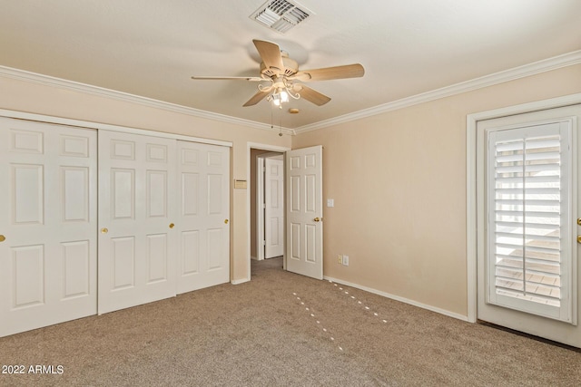 unfurnished bedroom with carpet flooring, ceiling fan, a closet, and ornamental molding