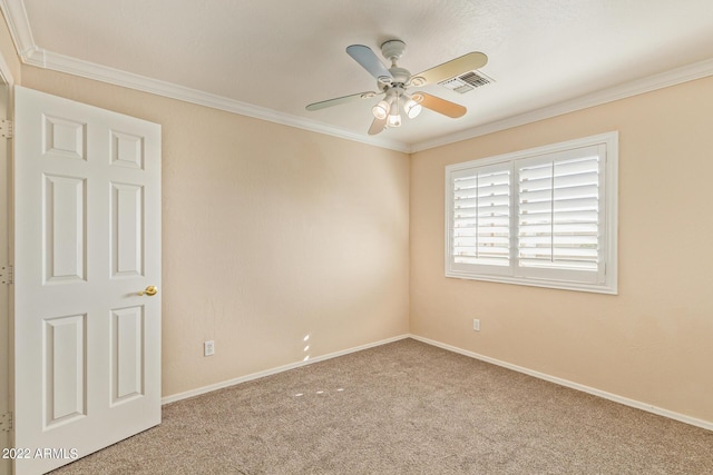 carpeted empty room featuring ceiling fan and crown molding