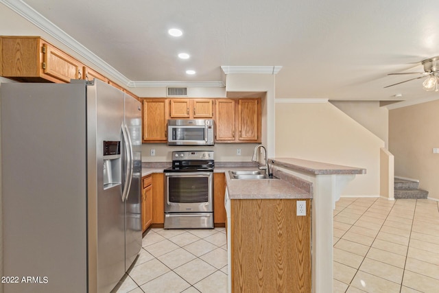 kitchen with sink, light tile patterned floors, ornamental molding, appliances with stainless steel finishes, and kitchen peninsula