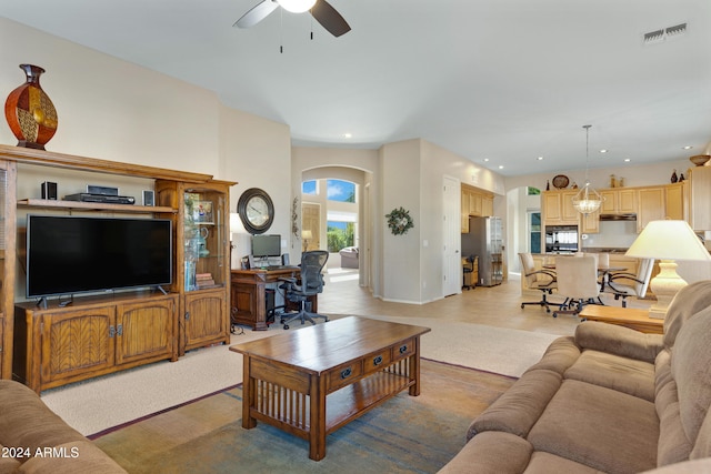 carpeted living room with ceiling fan