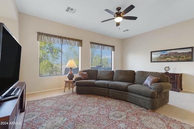 living room featuring ceiling fan and light colored carpet