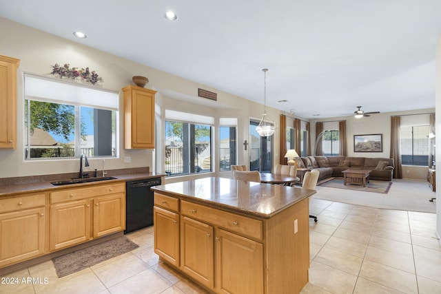 kitchen featuring sink, a center island, dishwasher, and a wealth of natural light