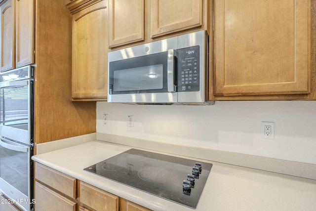 kitchen featuring light countertops and appliances with stainless steel finishes