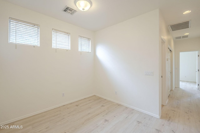 unfurnished room featuring visible vents, recessed lighting, baseboards, and light wood-style floors