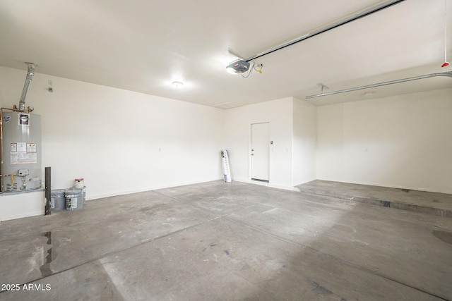 garage featuring baseboards, a garage door opener, and water heater