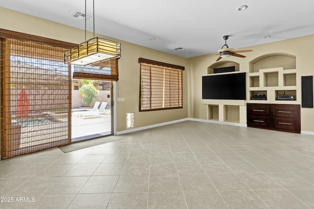 kitchen featuring visible vents, wall chimney exhaust hood, tasteful backsplash, arched walkways, and appliances with stainless steel finishes