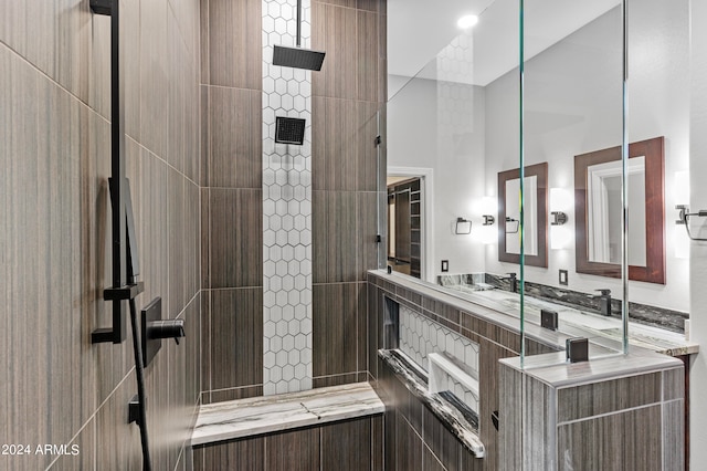 bathroom featuring vanity and tiled shower