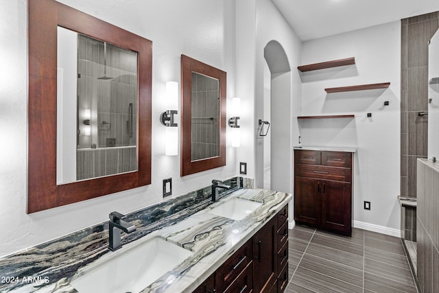 bathroom featuring vanity, walk in shower, and tile patterned flooring