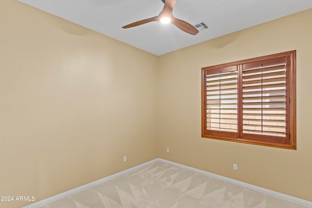 unfurnished room featuring ceiling fan and light carpet