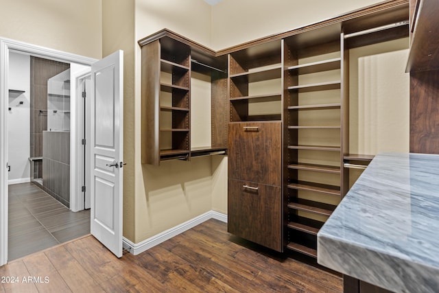 walk in closet featuring dark wood-style flooring