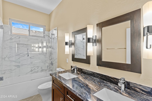 full bathroom with tile patterned floors, tiled shower / bath combo, vanity, and toilet