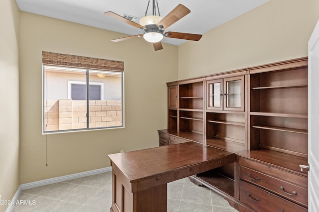 unfurnished office featuring a ceiling fan, light tile patterned floors, baseboards, and visible vents