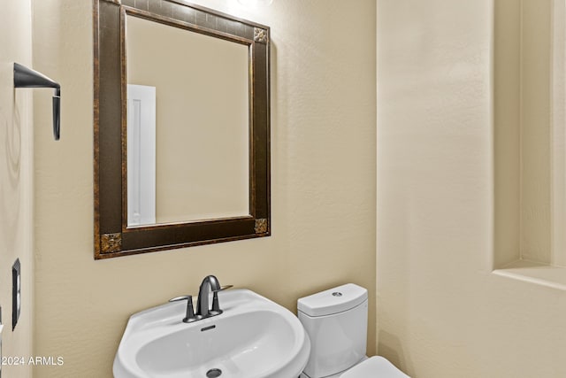 bathroom featuring toilet and a sink