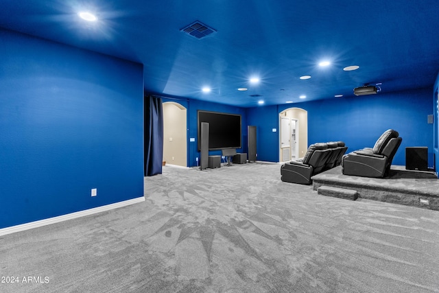 carpeted cinema room with baseboards, visible vents, arched walkways, and recessed lighting