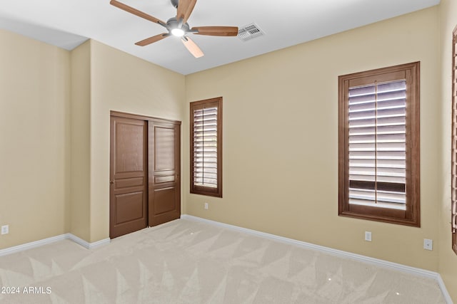 unfurnished bedroom featuring baseboards, visible vents, a closet, and carpet floors