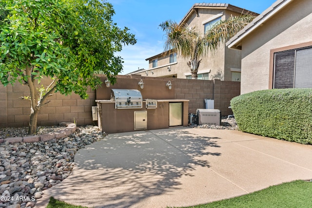 view of patio with exterior kitchen and area for grilling