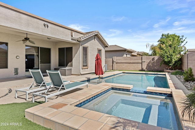 view of swimming pool featuring a patio, a fenced backyard, a pool with connected hot tub, and a ceiling fan