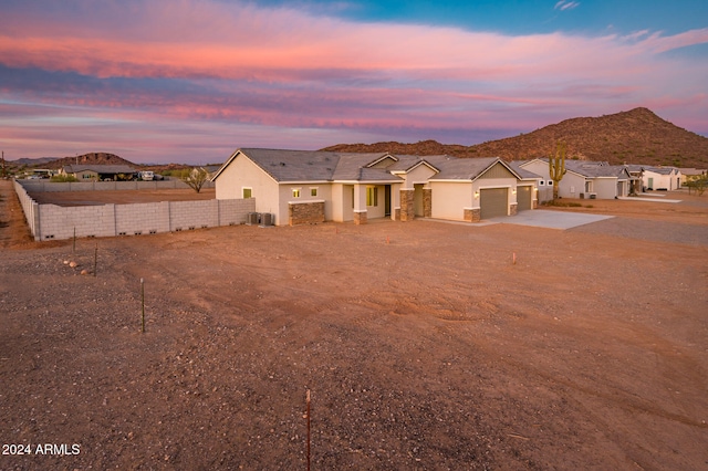 view of front facade featuring a garage and a mountain view