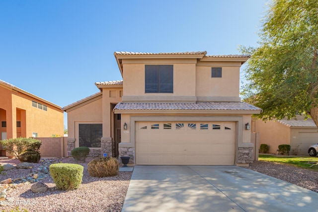 8637 W Kathleen Rd, Peoria, AZ 85382 - view of front of property featuring a tiled roof, concrete driveway, stucco siding, stone siding, and an attached garage