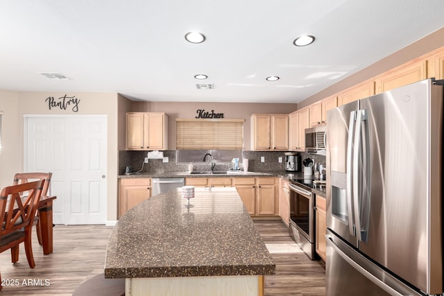 8637 W Kathleen Rd, Peoria, AZ 85382 - kitchen with visible vents, light brown cabinetry, tasteful backsplash, stainless steel appliances, and light wood-style floors