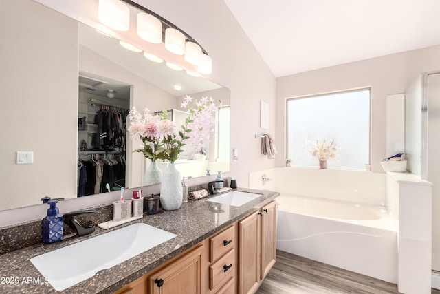 8637 W Kathleen Rd, Peoria, AZ 85382 - full bathroom featuring vaulted ceiling, a garden tub, and a sink