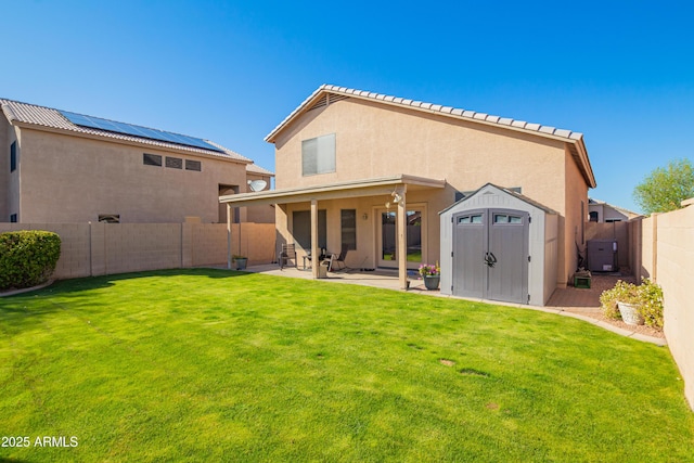 8637 W Kathleen Rd, Peoria, AZ 85382 - back of house with an outbuilding, a patio, a shed, a fenced backyard, and stucco siding