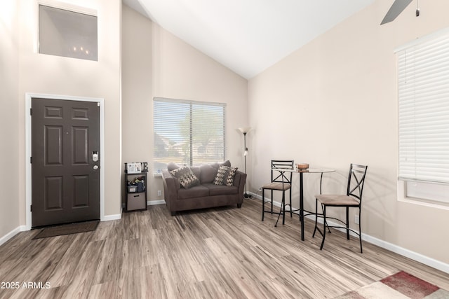 8637 W Kathleen Rd, Peoria, AZ 85382 - living area featuring ceiling fan, high vaulted ceiling, baseboards, and wood finished floors
