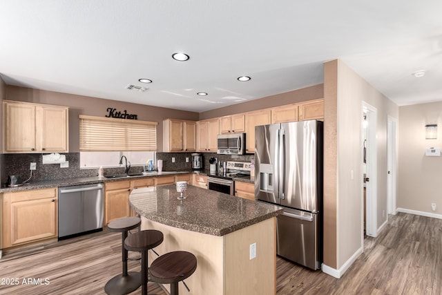 8637 W Kathleen Rd, Peoria, AZ 85382 - kitchen with light brown cabinetry, visible vents, appliances with stainless steel finishes, and a sink