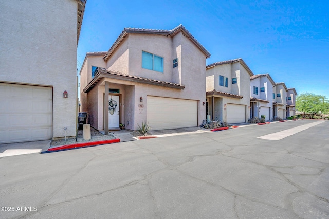 3034 N 39th St Unit 12, Phoenix, AZ 85018 - view of front facade featuring stucco siding, a tiled roof, an attached garage, and a residential view