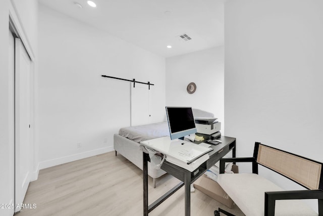 3034 N 39th St Unit 12, Phoenix, AZ 85018 - home office with light wood-type flooring, recessed lighting, and a barn door