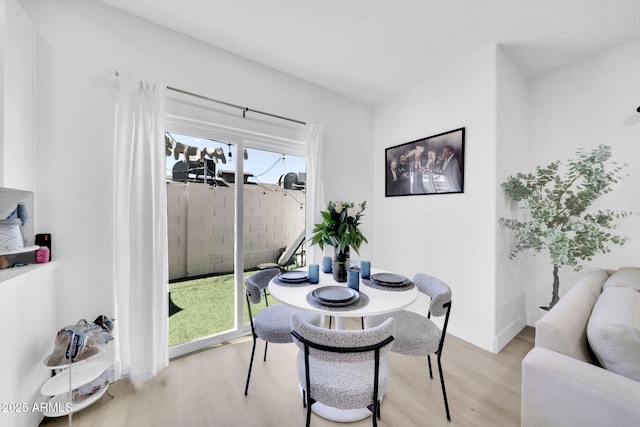 3034 N 39th St Unit 12, Phoenix, AZ 85018 - dining area featuring light wood-style floors and baseboards
