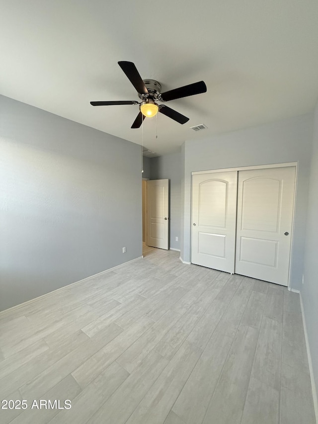 1241 E Palo Verde Dr, Casa Grande, AZ 85122 - unfurnished bedroom with light wood-type flooring, a closet, baseboards, and ceiling fan