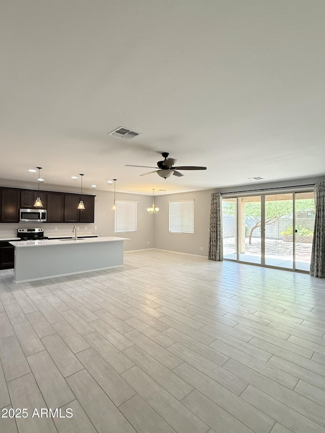 1241 E Palo Verde Dr, Casa Grande, AZ 85122 - unfurnished living room featuring a sink, ceiling fan, and light wood-style floors