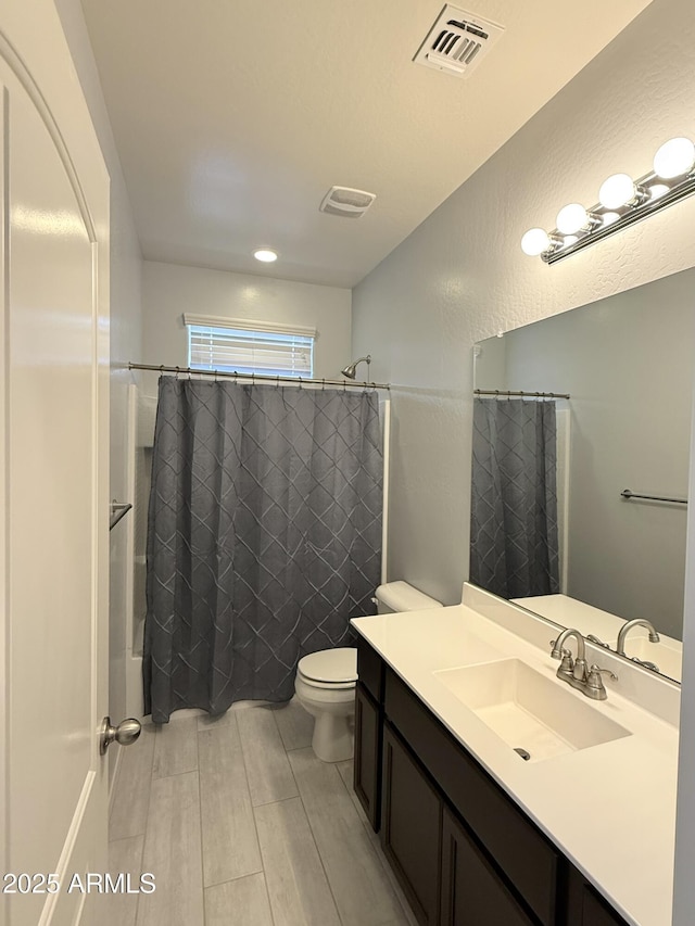 1241 E Palo Verde Dr, Casa Grande, AZ 85122 - full bathroom featuring vanity, toilet, shower / bath combination with curtain, and wood finished floors