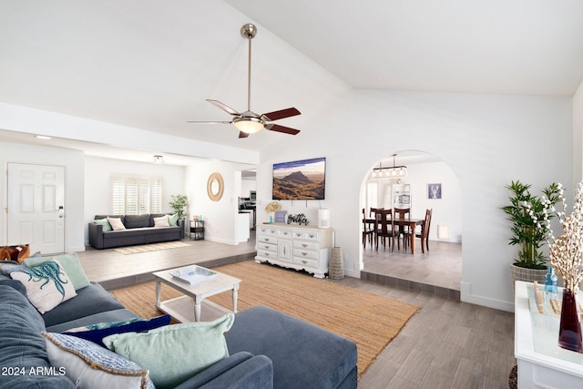 living room with hardwood / wood-style floors, ceiling fan, and lofted ceiling