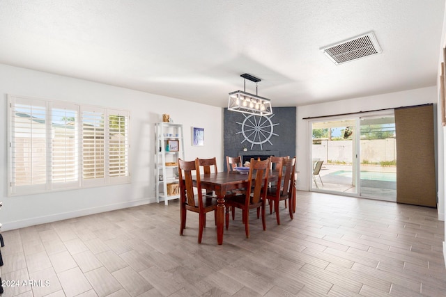 dining space featuring wood-type flooring and a healthy amount of sunlight