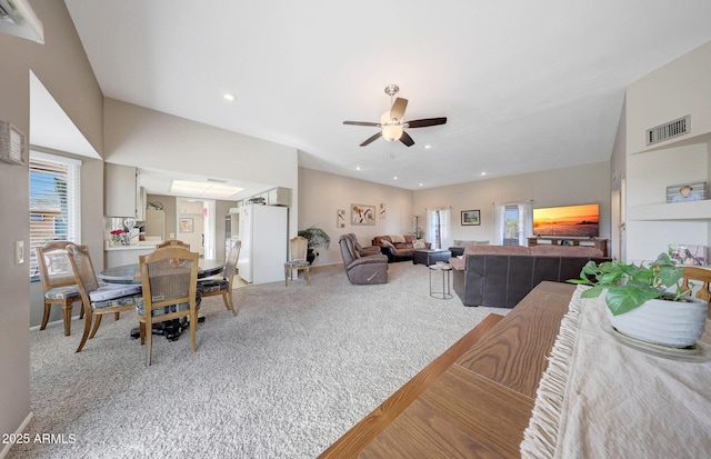 living room featuring ceiling fan and carpet