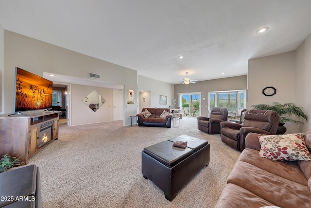 living room featuring ceiling fan and light carpet