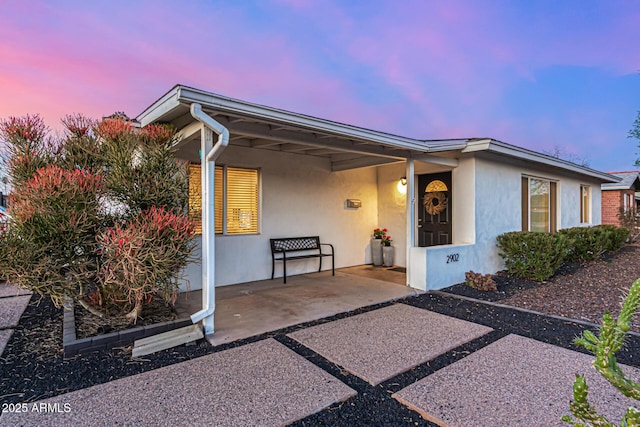 exterior space featuring stucco siding