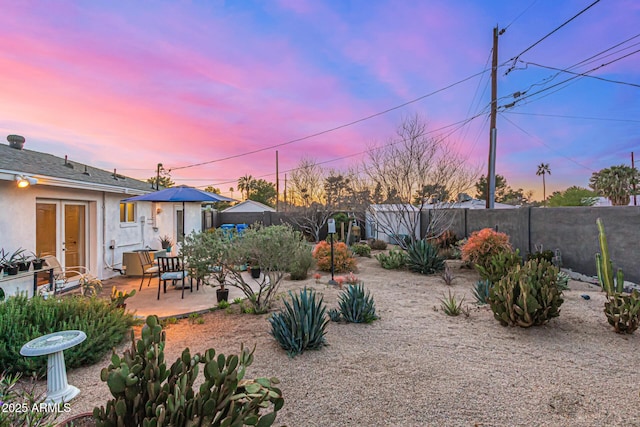 view of yard with french doors, a patio, and a fenced backyard